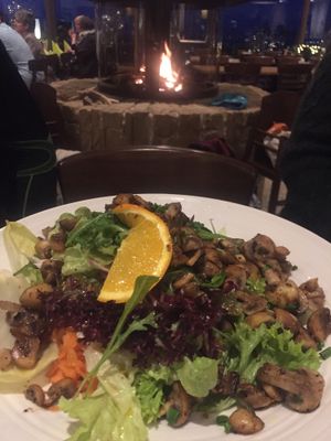 Fresh and huge vegan salad with grilled mushrooms in front of cozy fire place at Panorama in Winterberg