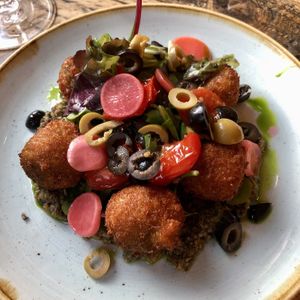 Sun dried tomato croquettes, black olive tapenade, pickled radish, mixed leaves  at The Spread Eagle in East London