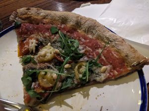 Slice of pizza at Flax & Kale - Sant Pere Mes in Barcelona