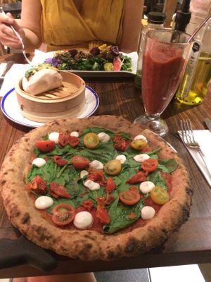 JB pizza and rejuvenator frozen smoothie, bao, and kale salad at Flax & Kale - Sant Pere Mes in Barcelona