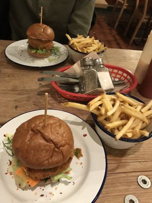 Tofish and kimchi burger and general Tso’s jackfruit burger with chips on the side at The Blacksmith & The Toffeemaker in London
