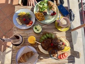 Pancake board, croissant, fresh orange juice and a breakfast menu on the other side   at Aloha Cafe in Sesimbra