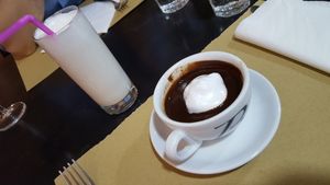 Warm almond milk and hot chocolate (order a half glass or ask for a second empty mug to share. It is like a melted candy bar) topped with a bit of warm almond milk. at Amico Bio - Spartacus Arena in Santa Maria Capua Vetere