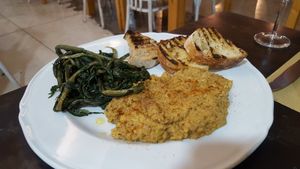 Chickpeas (labeled as hummus but served warm and chunkier than hummus) with vegetables. Gluten free without the bread.  at Amico Bio - Spartacus Arena in Santa Maria Capua Vetere