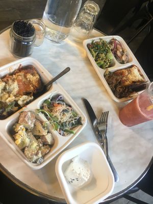 Lasagna (big pocket on both dishes), bean salad, potato salad, other greens, noodle dish, vegan feta  at Meshek Barzilay Deli in Tel Aviv