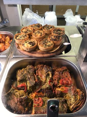 Mini vegan quiches and other hot food at Meshek Barzilay Deli in Tel Aviv