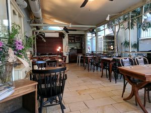 Enclosed outdoor dining at Meshek Barzilay Deli in Tel Aviv