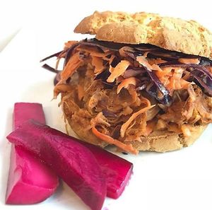 BBQ Jackfruit Burger and pink pickles. at Planted in Hamilton in Hamilton
