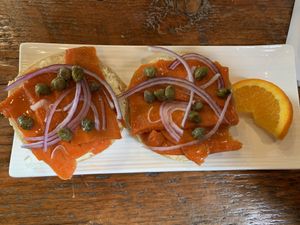 Smoked carrot marinated on cream cheese bagel with capers and red onion at Planted in Hamilton in Hamilton