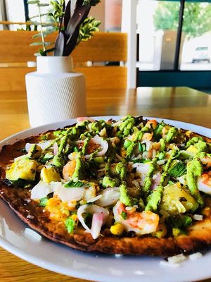 Roasted veggies, gulf shrimp, with garden tomato “salsa” on a gluten free crust topped with chimichurri. (can be made vegan) at Local Foods - Downtown in Houston