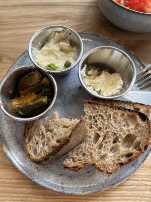 Bread with savoury spread, vegan butter and pickled cucumber  at Zaczyn in Krakow