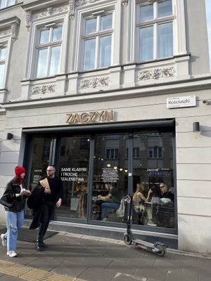 Outside of the store, showing people eating inside and others leaving with their goodies.   at Zaczyn in Krakow