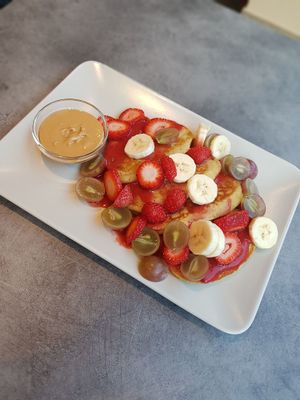 Vegan pancakes with peanut butter, fruit sirup and fruits (you can choose 2 of the toppings) at SweetFit in Bialystok