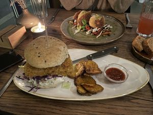 Smoked tempeh burger with spicy oven baked potato slices 28.00.- and Polenta Balls 29.00.-  at Karls Kraut in Luzern