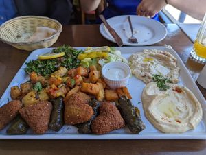 Vegetable mezze platter which is vegan apart from the yogurt dip. Falafel, stuffed fine leaves, Herby potatoes, hummus, baba ganoush, tabouleh, salad. at Mount Lebanon in Sheffield