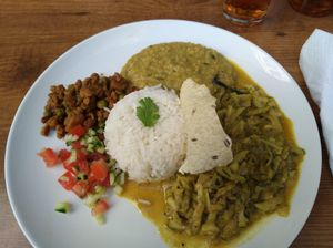 Dish of the day: dal, zucchini curry, salad, rice, textured soy and a piece of fried bread. at Mandala in Ravensburg