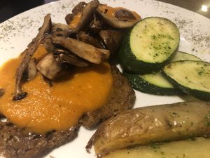 Seitan fricando with mushrooms and pumpkin sauce, grilled zucchini and potato wedge at Alive in Barcelona