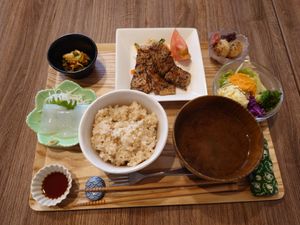 Okacon meal. It includes genmaidango, brown rice, miso soup, bbq dish, potato salad with vegetables, nata de coco sashimi, and kimchi.  at Grains in Nagoya