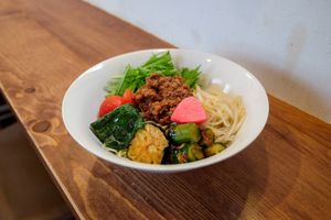 Dry tantan noodles with pickles, fried eggplant, kimchi cucumber, and other veggies at Grains in Nagoya