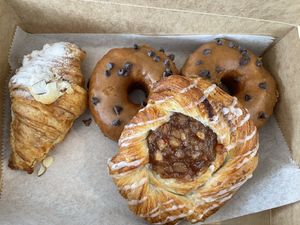 Vegan almond croissant, pumpkin chocolate vegan brioche doughnuts, and vegan apple danish  at The Sweet Praxis in Syracuse
