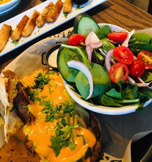Vegan Philly, side salad with vegan ranch, yucca fries in background   at The Howe in Minneapolis