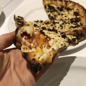 Pizza Napolitaine avec extra viande hachée (croûte avec extra fromage) at Vegan Rapide - Le Misanthrope in Montreal