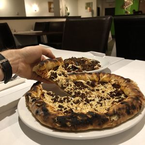 Pizza Napolitaine avec extra viande hachée et Poutine Orbit at Vegan Rapide - Le Misanthrope in Montreal