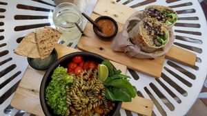 Mediterranean buddha bowl with pesto pasta, roasted veggies, tomatoes, spiced corn, greens with an olive sauce at Sapiens in Santiago