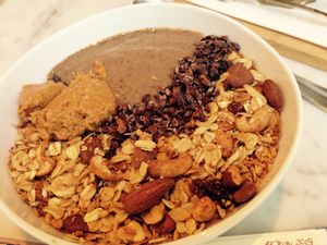 Smoothie Bowl wird toppings: cereal, Cacao and peanut butter  at My Goodness in Berlin