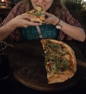 Happily eating the amazing Forrest Pizza at La Silapa in Luang Prabang
