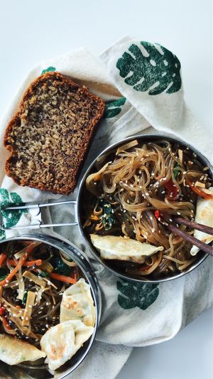 The delicious japchae in my to-go containers. Plus vegan banana bread!  at SaVeg Cafe in Calgary