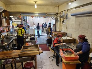 Seating in the back of the restaurant storefront at JinZhi Hong Zao Su Rou Yuan in New Taipei City
