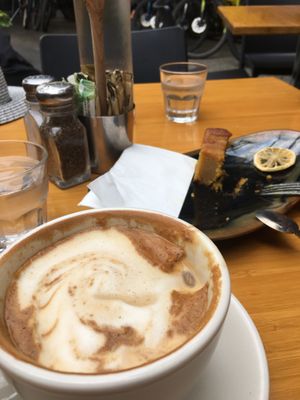 Flat white with soy milk and whats left of a yummy Orange cake  at The Cozy Corner in Taupo