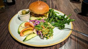 Plant based burger with side salad, plus roasted veg side. The salad in the foreground is included with the burger (the chips aren't vegan so it comes with the salad instead), and  at The Ship Inn in Lymington