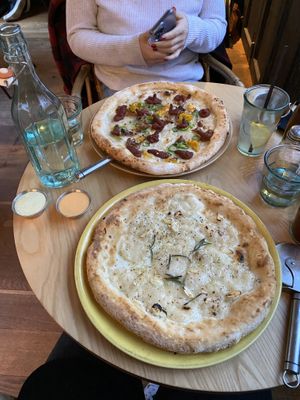 Glutenfree garlic sourdough with basil and maple sauce and “The One With The Nduja” pizza on the other side at Purezza Camden in London