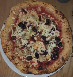 Four seasons pizza with cheese, olives, anchovies and mushrooms at Purezza Camden in London