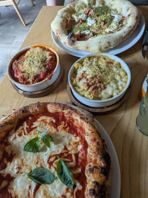 Margherita pizza, pistachio cream pizza, meatballs and Mac and cheese. at Purezza Camden in London