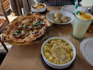 Mac and cheese, doughballs, meatballs, and parmigiana party pizza. Plus a smoothie with turmeric and tropical fruits. at Purezza Camden in London