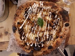 Coach Potato (wholegrain sourdough base). White base with smoked mozzarella, roasted aubergine, oven baked potatoes, basil leaves and shaved seitan, topped with garlic mayo, £11.9 at Purezza Camden in London