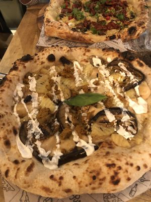 Couch potato pizza and roqueta pizza at the back. at Purezza Camden in London