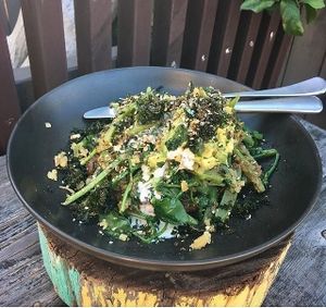 Vegan Green Bowl - chickpea and herb fritter carrot top pesto, grilled zucchini, pea tendril, Bowen semi dried cherry tomato sauté, asparagus, beet relish, smashed avocado and crispy kale; at Putia Pure Food Kitchen in Banyo