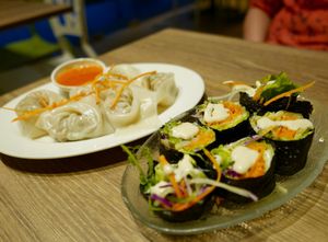 Veggie wrapped in nori sheets topped with cashew sauce & their popular dumplings  at Genesis 创世界素食馆 in Central Singapore