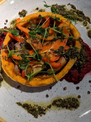 Caramelised onion tart with beetroot hummous, pesto and roasted seeds. at The Castle in Wakefield