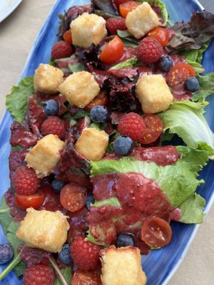 Tempura from almond mozzarella on salad with red berries  at Hakuna Matata Veggie in Madrid