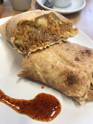 Burrito with jackfruit, rice and hummus and a sweet chilli dressing on the side at Marwick's Vegan Kitchen in Dundee