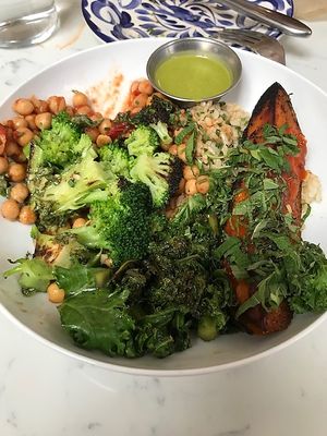 Basic Bowl consisting of brown rice, sesame kale, chickpeas, gilled broccoli, grilled sweet potato, chiles, & magic green sauce.  Very good and freshly prepared. at Basic Kitchen in Charleston
