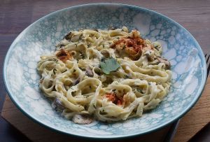 RICE NOODLES WITH MUSHROOMS IN CREAMY SAUCE  (Rice Noodles, Champignon, Cashews milk, Nutritional Yeast, Vegan Bacon, Garlic) at by Cafe in Tegallalang