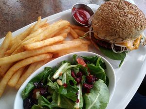 Monster burger with fries and salad at Ek's Grill in Kelowna