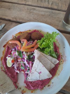 I had already started to eat before I took a photo, so that's why there is a bit missing. This is falafel with beetroot houmou, salad and flat bread. at Shady Lane in Mirissa