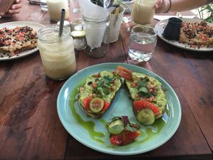 Avocado on toast and banana peanut butter toast in the background at Nomad Café | Boutique in Weligama